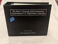 Photo of the black hardcover booklet with title and Postal Commemorative Society imprint.
