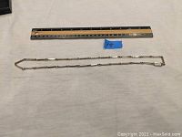 Full necklace laid flat next to a ruler showing length of approximately 20 inches.
