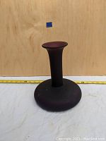 Front view of mid century purple matte vase showing rounded base and narrow neck.