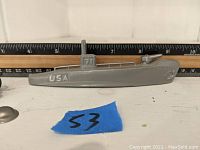 Grey lead submarine with USA marking and conning tower, approximately 9 inches long.