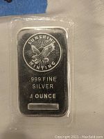 Front of 1 oz silver bar showing Sunshine Minting logo, purity and weight markings
