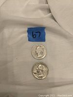 Two silver quarters front (obverse) side showing George Washington profile.