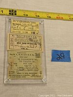 Three vintage railroad tickets encased in lucite collector case with measuring tape showing approximately 7 inches in length. Tickets include travel from New York to Boston, various dates, and companies Pullman and N.Y., N.H. & H.R.R. Co.