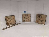 Three vintage pottery wall tiles displayed together, showing rough edges and nude female figures in varied poses with a ruler for size reference.