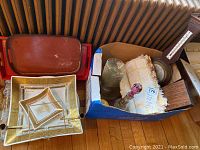 Wooden barometer, cut glass decanter, glass cups and additional glassware in cardboard box, decorative trays on floor