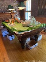 Full view of pool table in room with accessories on top