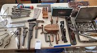 Overall view of assorted antique hand tools laid out on table