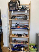 Front view full shot of the wooden bookcases joined at center with various items on shelves, showing height and shelf spacing.