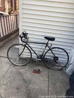 Side view of the Bridgestone vintage road bike leaning against siding.