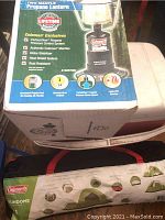 Box of Coleman two mantle propane lantern with features and warranties listed.