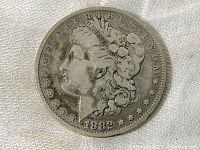 Obverse side of 1882 Morgan silver dollar showing Lady Liberty's profile and date 1882.