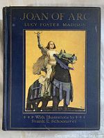 Front and spine cover of the 1918 Joan of Arc book showing blue cover with gold text and illustration of Joan on horse.