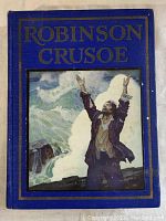 Front cover showing blue hardcover with gold embossed text and illustrated inset with a man raising arms on a rocky shore.