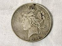 Obverse side of 1934 Peace Dollar showing Lady Liberty with wear from circulation