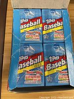 Top view of one opened wax-pack box showing 4 sealed 1992 Topps baseball card wax packs inside with the blue packaging and player image.