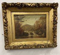 Full view of the antique landscape painting with heavy relief gold gilt frame.