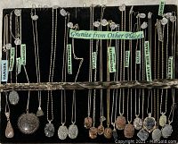 20 granite necklaces displayed on black velvet