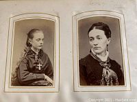 Two interior pages each with two arch-top mounted black-and-white portrait prints of a young girl and a woman.