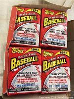 Top view of the unopened box showing four visible packs with the 1991 Major League Baseball Topps branding and promotional sweepstakes information.