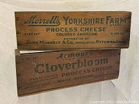 Side view of both cheese crates stacked showing Morrell's Yorkshire Farm Brand and Armour's Cloverbloom brand names and product details.