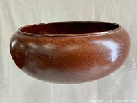 Side profile showing bowl shape and polished wood grain