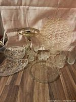 Photo showing the overall lot with various crystal items arranged, including the antique lamp and several dishes and glassware.