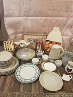 Full lot showing kettle, blender, teacups, plates, and other dishware