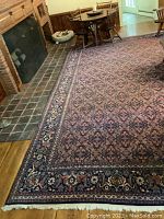 Full room view of rug laid before fireplace and dining area