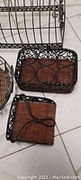 Close-up of two wicker baskets with iron wire frame and decorative scrollwork