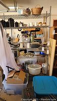 Photo showing a large metal wire storage rack with multiple shelves filled with various kitchen and household items.