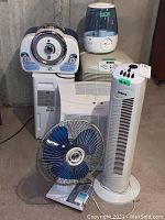 Photo showing all items together: GermGuardian air purifier, Vicks humidifier, Nordik tower fan, Bionaire fan, Denby humidifier, Kenmore humidifier, oscillating fan.
