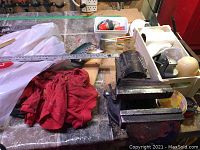 Bench vise with ruler laid across, red cloth rag next to it on tiled workbench.