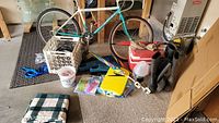 Full view of the bicycle, boots, cooler, chalk bucket, lawn chair cushion, and assorted swim gear