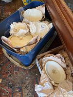Overall view of blue bin containing assorted Lenox dishes: plates, saucers, platter, serving bowl