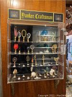 Full acrylic display case with four shelves of finials and Yankee Craftsman sign
