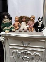 Full view of all five dolls, showing sizes and overall wear