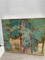Front view of the signed Asian painting showing turquoise foliage and brown tree trunks, quail bird near bottom left, acrylic edged frame.