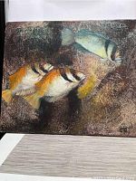 Full view of the signed oil on canvas painting showing three fish with detailed texture and color.