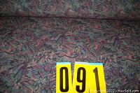 Photo of upholstery fabric laid out showing extensive multicolor abstract pattern with purples, blues, pinks, and beige hues.