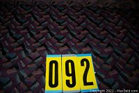 Full view of the bolt of upholstery fabric with geometric pattern and auction lot number 092