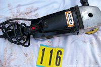 Top view of Craftsman commercial grinder showing the power cord, on/off switch, and Craftsman logo on black body.