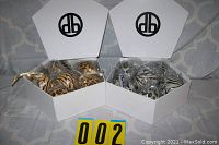 Two open white hexagonal boxes containing 6 ornaments each with animal print patterns, one box has golden-brown shades with leopard and tiger stripes, other has black-and-white zebra stripes.