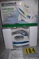 Kenmore iron in original box showing product features on box and iron inside protective foam packaging.