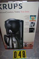 Full view of the Krups Aroma Control Therm Time Steel coffee maker box showing product features and stainless steel carafe.