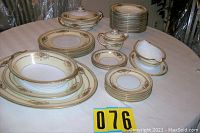 Full view of Noritake Cherita china set, various plates, bowls, serving pieces arranged on table