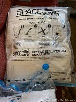Packed Space Saver Jumbo vacuum storage bag with compressed bedding items and usage instructions visible.