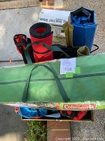 Overview of tent carry bag, rolled mats, boxes and other gear