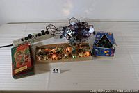 Photo showing all four sets of vintage lights including the NOMA C-6 bulb set in original box, oriental lantern lights, snowball lights, and replacement bulbs set.
