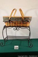 Basket with holiday fabric liner set inside wrought iron stand