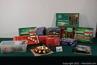 Lot of boxed and open sets of Christmas lights displayed on table, including Foremost brand and various colors and types